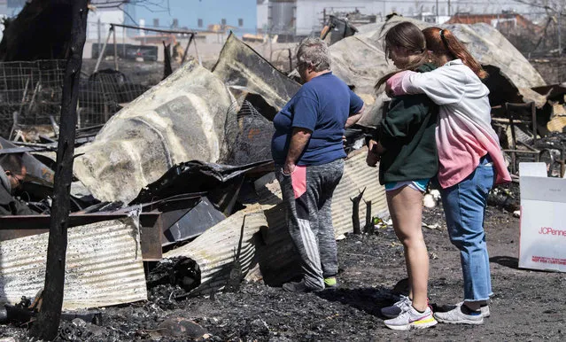 Chandra Campos hugs her daughter Alyssa Carlos, 14, as they search through the remains of their home in Monte Vista, Colo., Friday, April 22, 2022, after a fire fueled by high winds Wednesday burned 17 structures and displaced six families. Campos and her family lost everything except the clothes on their backs, two dogs and a cat. (Photo by Christian Murdock/The Gazette via AP Photo)
