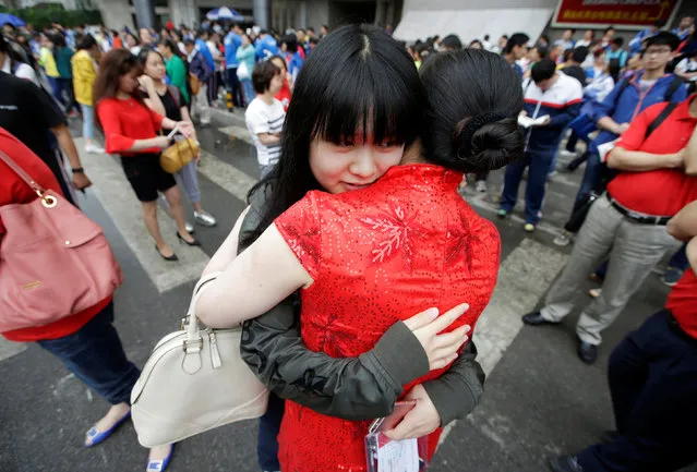 A student hugs her teacher as she arrives at the Chen Jinglun High School for the first part of China's annual national college entrance exam, in Beijing, China, June 7, 2016. (Photo by Jason Lee/Reuters)