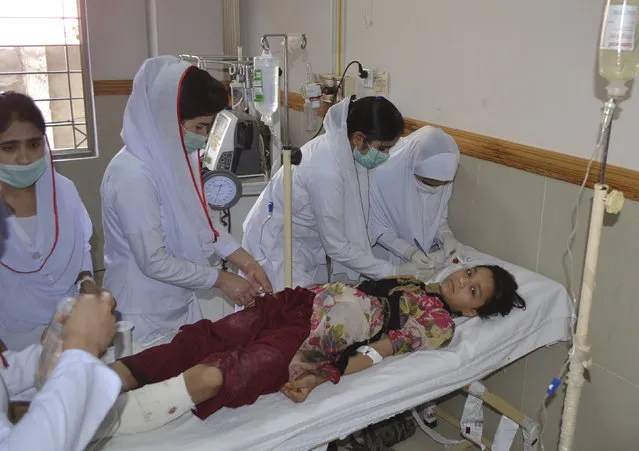 Pakistani nursing staff attend an injured girl at a hospital in Quetta, Pakistan, Friday, June 23, 2017. A powerful bomb went off near the office of the provincial police chief in southwest Pakistan on Friday, causing casualties, police said. (Photo by Arshad Butt/AP Photo)