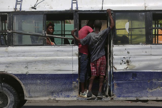 Passengers ride on a bus in downtown Port-au-Prince, Haiti, Friday, August 23, 2024. (Photo by Odelyn Joseph/AP Photo)