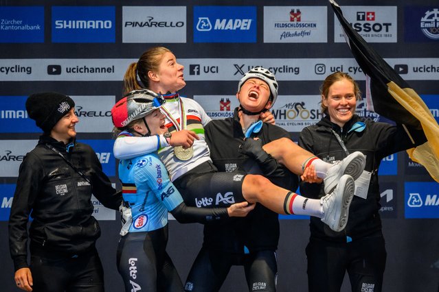 Belgian team celebrates with winner Belgium's Lotte Kopecky (C) during the podium ceremony of the women's Elite Road Race cycling event as part of the UCI 2024 Road World Championships, in Zurich, on September 28, 2024. (Photo by Fabrice Coffrini/AFP Photo)