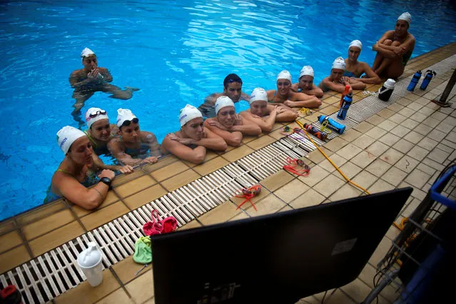 Brazil's synchronised swimming team watches a video during a training session at the Maria Lenk Aquatic Centre in Rio de Janeiro, Brazil, May 20, 2016. (Photo by Pilar Olivares/Reuters)
