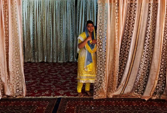 An Afghan Hindu woman arrives for a religious ceremony inside a Gurudwara, or a Sikh temple, in Kabul, Afghanistan June 8, 2016. (Photo by Mohammad Ismail/Reuters)