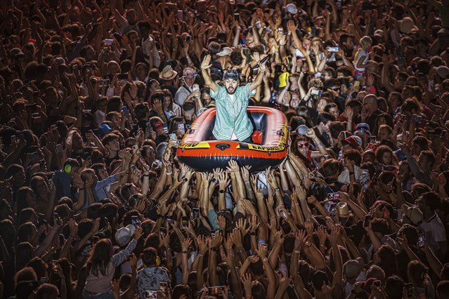 Olivio Ordonez from the French hip hop duo “Bigflo & Oli” (Bigflo et Oli) crowd surfs in an inflatable boat as they perform on the main stage during the 46th edition of the Paleo Festival in Nyon, Switzerland on Friday, July 21, 2023. (Photo by Valentin Flauraud/Keystone via AP Photo)