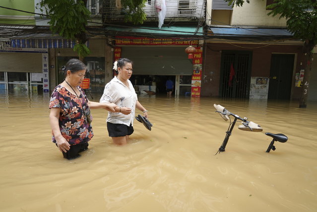 People wade in a flooded street in the aftermath of Typhoon Yagi, in Hanoi, Vietnam on Thursday, September 12, 2024. (Phoot by Hau Dinh/AP Photo)