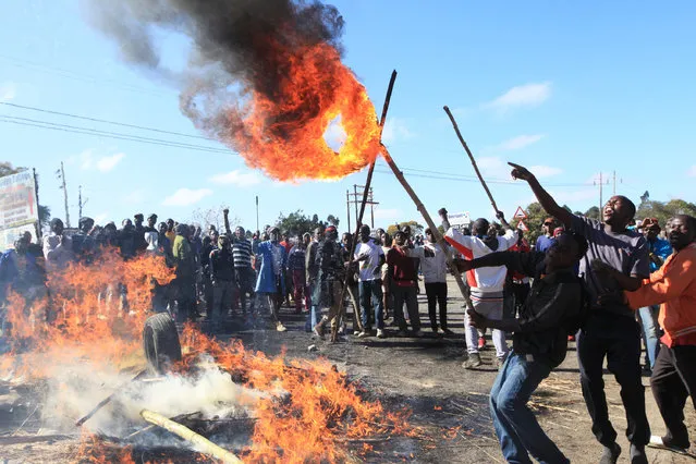 Rioters battle with Zimbabwean police in Harare, Monday, July, 4, 2016. (Photo by Tsvangirayi Mukwazhi/AP Photo)