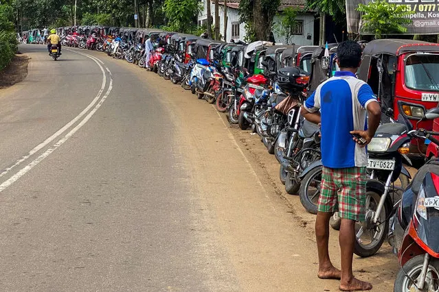 Motorists queue along a street to buy fuel at a Ceylon petroleum corporation fuel station in.Pugoda, some 50 km from Colombo on June 23, 2022. (Photo by Ishara S. Kodikara/AFP Photo)