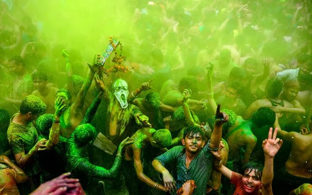 Revellers dance as they celebrate Holi, the spring festival of colours, in Allahabad on March 10, 2020. (Photo by Sanjay Kanojia/AFP Photo)