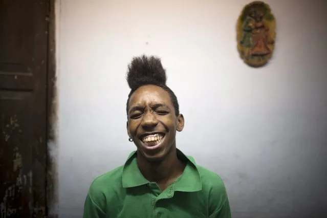 Student Yordanis Donatiel, 16, reacts to friends (not pictured) at his home in downtown Havana, April 9, 2015. (Photo by Alexandre Meneghini/Reuters)