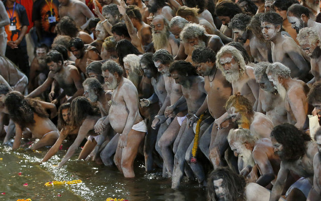 Naked Hindu holy men prepare to bath in the Godavari River during Kumbh Mela, or Pitcher Festival, at Trimbakeshwar in Nasik, India, Saturday, August 29, 2015. (Photo by Rajanish Kakade/AP Photo)