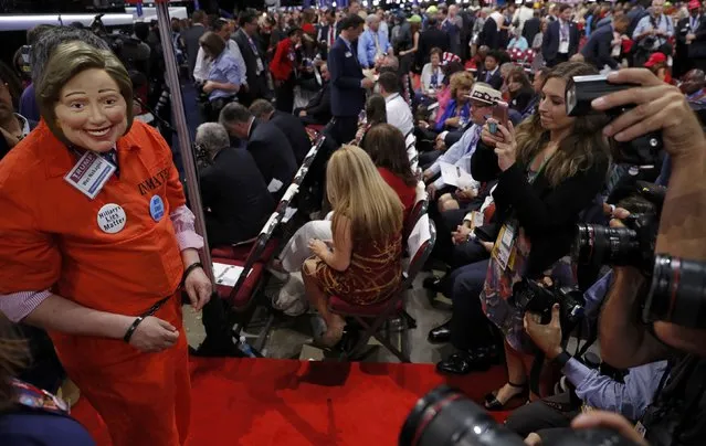 A delegate wearing a mask of Democratic presidential candidate Hillary Clinton, as well as handcuffs and a prison jumpsuit,  faces photographers on the convention floor before the start of the final day of the Republican National Convention in Cleveland, Ohio, U.S. July 21, 2016. (Photo by Brian Snyder/Reuters)