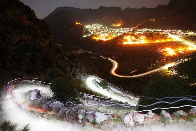 Trails of headlamps are seen in the night as runners make their way to the finish line during the XVII 101km competition on a mountain on the outskirts of Montejaque, near Ronda, southern Spain. (Photo by Jon Nazca/Reuters)
