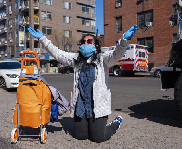 A woman and local resident, Amella, kneels as she prays for the victims of the coronavirus outside the emergency room of the Elmhurst Hospital Center on April 06, 2020 in the Queens borough of New York City. Hospitals in New York City, which had been especially hard hit by the coronavirus, are facing shortages of beds, ventilators and protective equipment for medical staff. New York City had more than 72,000 confirmed COVID-19 cases as of this afternoon, according to health officials. (Photo by Robert Nickelsberg/Getty Images)