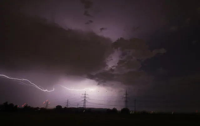 Lightning flashes across the night sky in Stuttgart, Geremany, Friday, May 20, 2022. (Photo by Andreas Rosar/dpa via AP Photo)