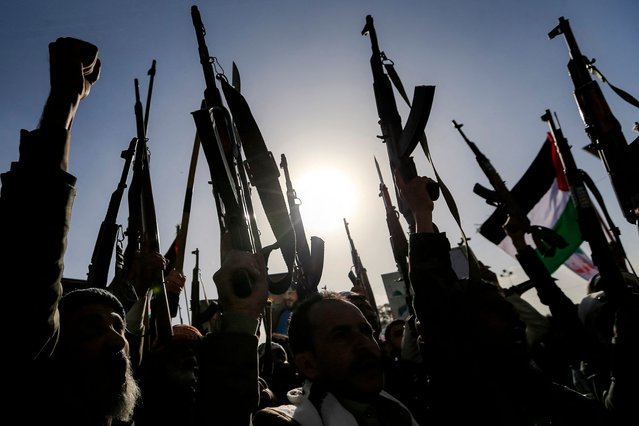 Demonstrators chant slogans and raise up assault rifles during a rally denouncing Israel and in solidarity with Palestinians in the Huthi-controlled capital Sanaa on January 3, 2025. (Photo by Mohammed Huwais/AFP Photo)