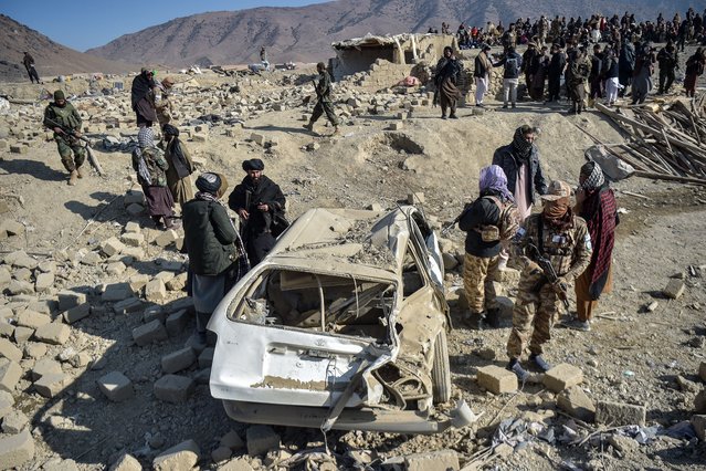 Taliban security personnel inspect a damaged car two days after air strikes by Pakistan in the Barmal district of eastern Paktika province on December 26, 2024. Pakistan air strikes in an eastern border region of Afghanistan killed 46 civilians, the Taliban government said on December 25, whilst a Pakistan security official said the bombardment had targeted “terrorist hideouts”. (Photo by Ahmad Sahel Arman/AFP Photo)