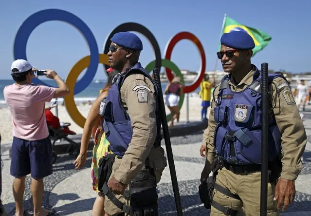 Members of the municipal guard patrol in front of Rio 2016 Olympic rings along Copacabana beach in Rio de Janeiro, Brazil, August 5, 2016. (Photo by Benoit Tessier/Reuters)