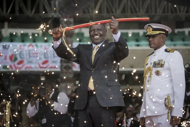 Kenya's new president William Ruto holds up a ceremonial sword as he is sworn in to office at a ceremony held at Kasarani stadium in Nairobi, Kenya Tuesday, Septembe 13, 2022. William Ruto was sworn in as Kenya's president on Tuesday after narrowly winning the Aug. 9 election and after the Supreme Court last week rejected a challenge to the official results by losing candidate Raila Odinga. (Photo by Brian Inganga/AP Photo)