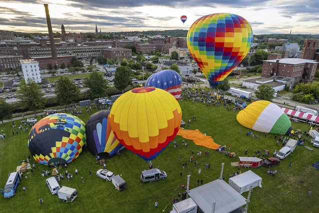 Balloons lift off Friday morning, August 19, 2022, from Simard Payne Memorial Park in Lewiston, Maine, on the first day of the 2022 Great Falls Balloon Festival in Lewiston after being cancelled for the past two years because of COVID-19. (Photo by Russ Dillingham/Sun Journal via AP Photo)