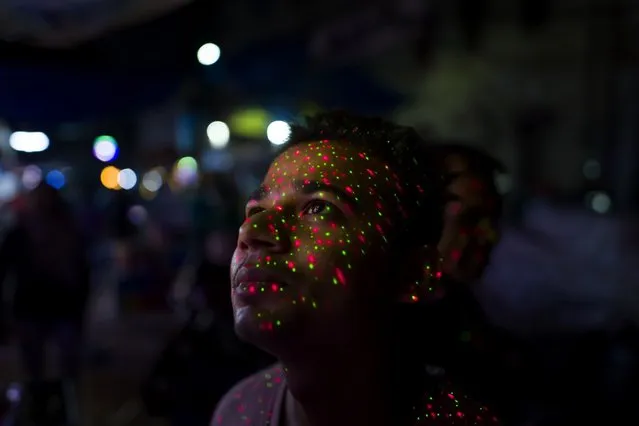 Lights from a decorative LED fall on a customer ahead of the festival of Diwali in New Delhi, India on Sunday, October 23, 2022. Indian shoppers are back in force online and in stores, splurging this festive season after the coronavirus pandemic damped celebrations and consumption in previous years. (Photo by Anindito Mukherjee/Bloomberg)