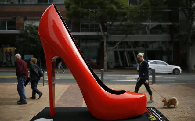 People walk past a giant high heeled shoe in Wellington, New Zealand April 6, 2014. (Photo by Phil Noble/Reuters)