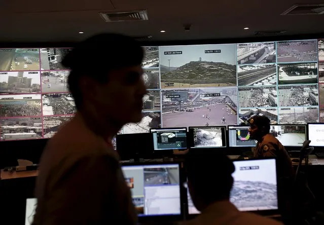 Saudi policemen look at monitor screens showing footage from cameras set up around the holy places, during a tour for journalists, on the second day of Eid al-Adha in Mina near the holy city of Mecca September 25, 2015. (Photo by Ahmad Masood/Reuters)