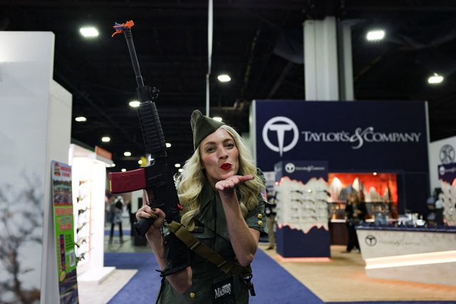 Miranda Stratton poses for a photograph with a gun during the NRA annual meeting in Atlanta, Georgia, U.S. April 27, 2025. (Photo by Jeenah Moon/Reuters)
