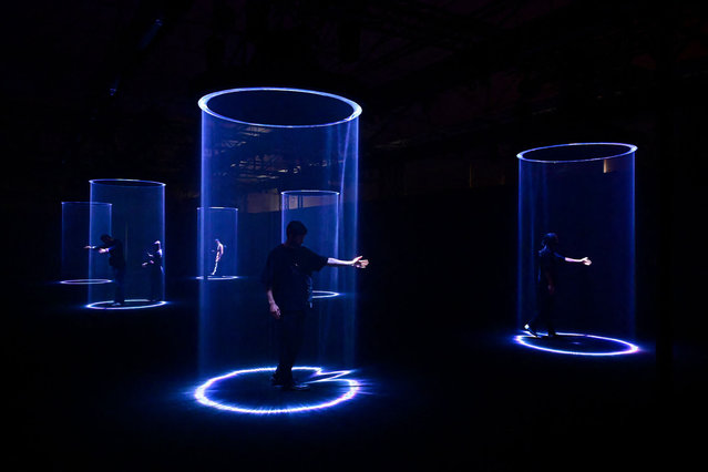 People interact with an installation entitled “Making the Invisible Visible” by Google as part of the Fuorisalone 2025 event, on the eve of the Milan Design Week, in Milan, on April 7, 2025. (Photo by Piero Cruciatti/AFP Photo)