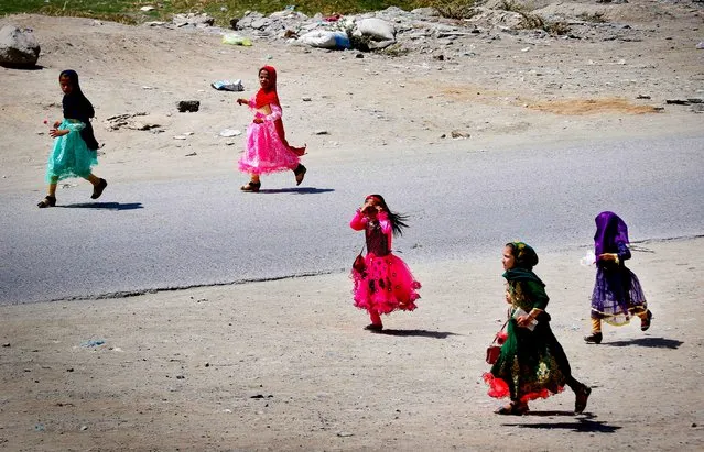 Afghan girls play as they celebrate the Muslim festival of Eid al-Adha in Kabul, Afghanistan, 31 July 2020. Eid al-Adha is the holiest of the two Muslims holidays celebrated each year, it marks the yearly Muslim pilgrimage (Hajj) to visit Mecca, the holiest place in Islam. Muslims slaughter a sacrificial animal and split the meat into three parts, one for the family, one for friends and relatives, and one for the poor and needy. (Photo by Hedayatullah Amid/EPA/EFE)