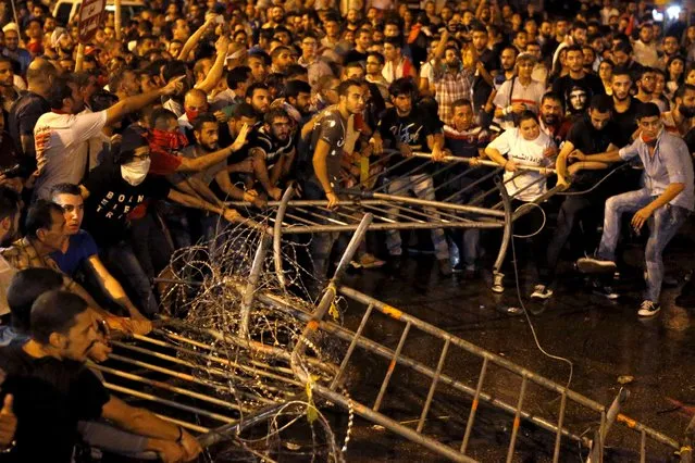 Lebanese protesters remove barriers during a protest in Martyr square, Downtown Beirut, Lebanon October 8, 2015. Lebanese security forces fired a water cannon at scores of anti-government protesters on Thursday, Reuters witnesses said. The crowd chanted "the people want the fall of the regime" as riot police surrounded them in downtown Beirut. (Photo by Mohamed Azakir/Reuters)