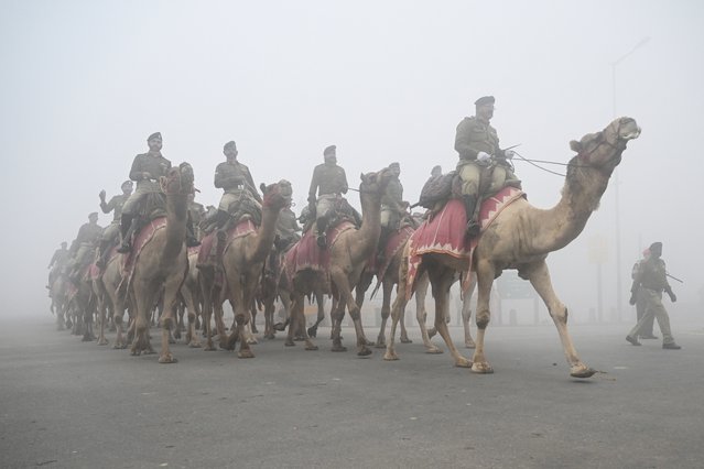Border security force (BSF) camel mounted soldiers take part in rehearsals for the upcoming Republic Day parade amid dense fog on a cold winter morning, in New Delhi on January 15, 2025. (Photo by Arun Sankar/AFP Photo)
