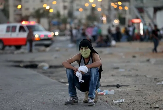 A Palestinian protester rests during clashes with the Israeli troops near the Jewish settlement of Bet El, near the West Bank city of Ramallah October 14, 2015. Seven Israelis and 31 Palestinians, including children and assailants, have been killed in two weeks of bloodshed in Israel, Jerusalem and the occupied West Bank. (Photo by Mohamad Torokman/Reuters)
