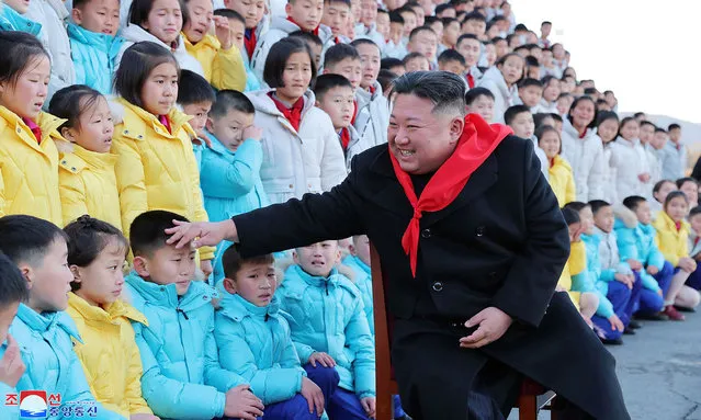 This picture taken in late December 2022 and released from North Korea's official Korean Central News Agency (KCNA) on January 2, 2023 shows North Korea's leader Kim Jong Un meeting with representatives who participated in the 9th meeting of the Korean Boy Scouts during a commemorative photo session in Pyongyang. (Photo by KCNA via KNS/AFP Photo)