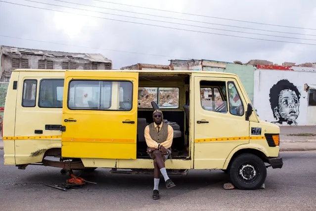 DJ Evans Mireku Kissi poses for a photograph beside a van in Jamestown, Accra, Ghana, June 12, 2015. (Photo by Francis Kokoroko/Reuters)