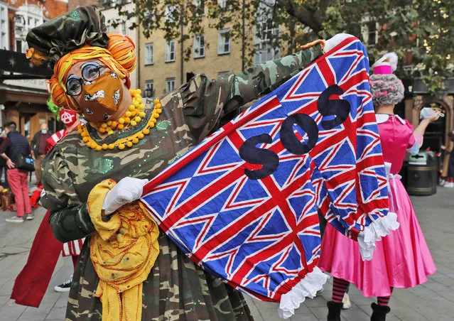 Actors dressed as pantomime dames pose for photographers before they march on Parliament to demand more support for the theatre sector amid the COVID-19 pandemic, in London, Wednesday, September 30, 2020. (Photo by Frank Augstein/AP Photo)