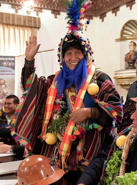 Bolivia's President Evo Morales, wearing typical clothes of “Tinku” traditional ritual, waves to supporters during a ceremony in Potosi, Bolivia, October 2, 2016. (Photo by Freddy Zarco/Reuters/Courtesy of Bolivian Presidency)