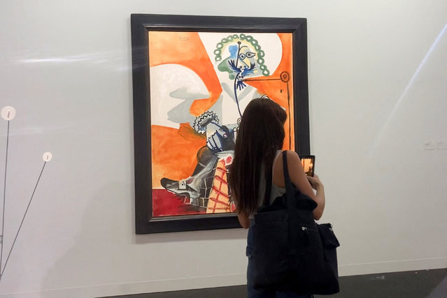 A woman stands in front of a Pablo Picasso painting displayed at the Hauser & Wirth gallery section at Art Basel, in Basel, Switzerland, on June 17, 2025. (Photo by Marleen Kaesebier/Reuters)