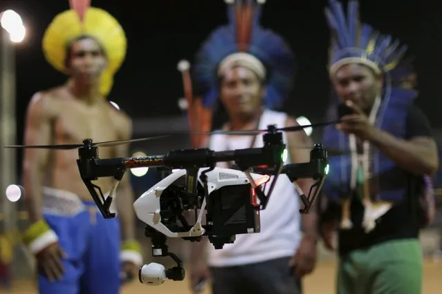 Indigenous men from several tribes look at a drone during the first World Games for Indigenous Peoples in Palmas, Brazil, October 28, 2015. (Photo by Ueslei Marcelino/Reuters)