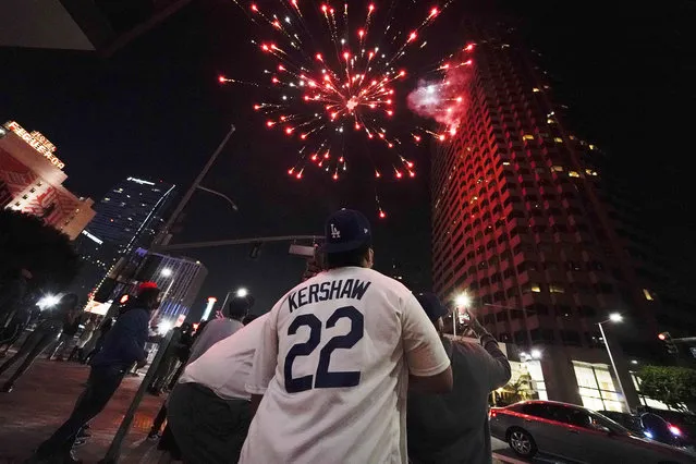 Baseball fans celebrate downtown after the Los Angeles Dodgers won the World Series over the Tampa Bay Rays Tuesday, October 27, 2020, in Los Angeles. (Photo by Ashley Landis/AP Photo)