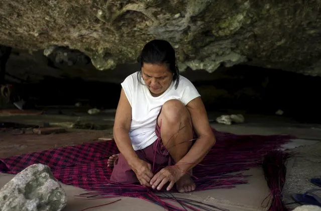 A Typhoon Haiyan survivor weaves a mat at Caub cave in Basey, Samar in central Philippines November 2, 2015, ahead of the second anniversary of the devastating typhoon that killed more than 6,000 people in central Philippines. (Photo by Lorgina Minguito/Reuters)