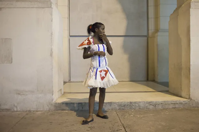 A dancer takes a break during the celebrations of the 54th anniversary of the creation of the Committees for the Defense of the Revolution (CDR) in Havana, September 28, 2014. (Photo by Alexandre Meneghini/Reuters)