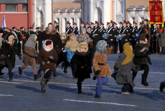 Children and a woman run while taking part in a performance part of a military parade on the Red Square in central Moscow, Russia, November 7, 2015. (Photo by Maxim Shemetov/Reuters)