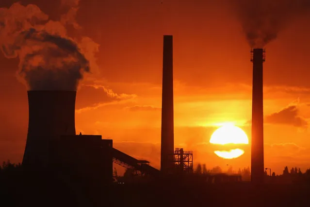 The sun sets behind the Tata Steel processing plant at Scunthorpe which may make 1200 workers redundant on October 19, 2015 in Scunthorpe, England. (Photo by Christopher Furlong/Getty Images)