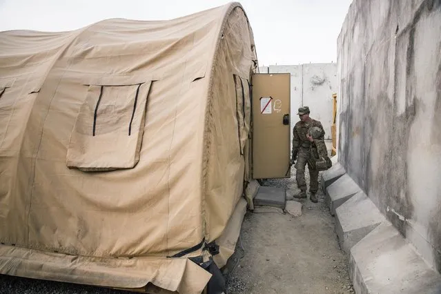 A U.S. soldier from the 3rd Cavalry Regiment returns to his quarters after an exercise on forward operating base Gamberi in the Laghman province of Afghanistan December 24, 2014. (Photo by Lucas Jackson/Reuters)