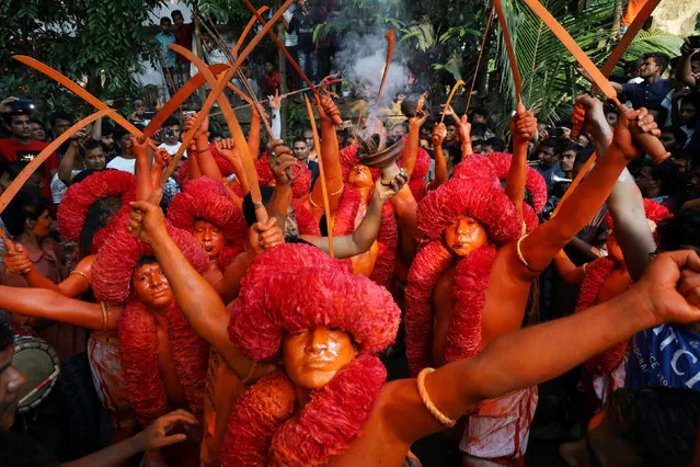 Hindu devotees dance on the street as they celebrate Lal Kach festival in Narayanganj, Bangladesh, April 13, 2018. (Photo by Mohammad Ponir Hossain/Reuters)