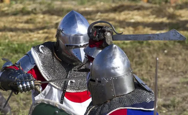 A member of team Japan, left, fights against a Czech Republic contestant during the “Battle of Nations” in Aigues-Mortes, southern France, Friday, May 10, 2013 where Middle Ages fans attend the historical medieval battle  competition. The championship will be attended by 22 national teams, which is twice the number it was last year. The battle lasts until May 12.(Photo by Philippe Farjon/AP Photo)