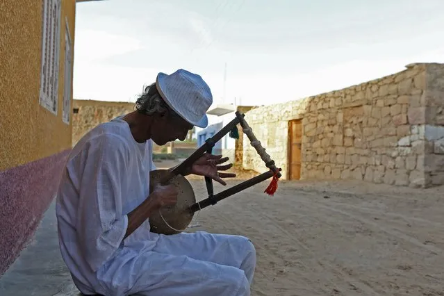 A man plays music on a traditional musical instrument in the Nubian village of Adindan near Aswan, south of Egypt, September 30, 2015. (Photo by Mohamed Abd El Ghany/Reuters)