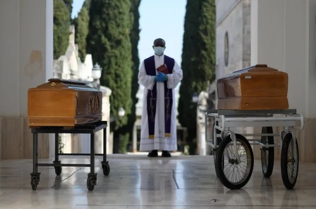 Coffins of two victims of coronavirus disease (COVID-19) are seen during a burial ceremony in the southern town of Cisternino, Italy on March 30, 2020. (Photo by Alessandro Garofalo/Reuters)