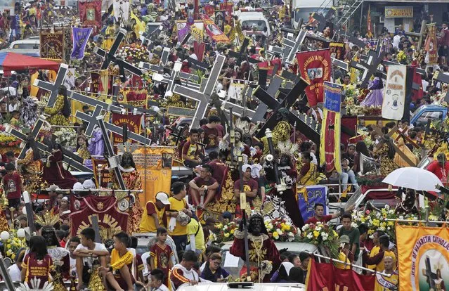 Devotees with replica statues of the Black Nazarene participate in a procession in Manila January 7, 2015. (Photo by Romeo Ranoco/Reuters)