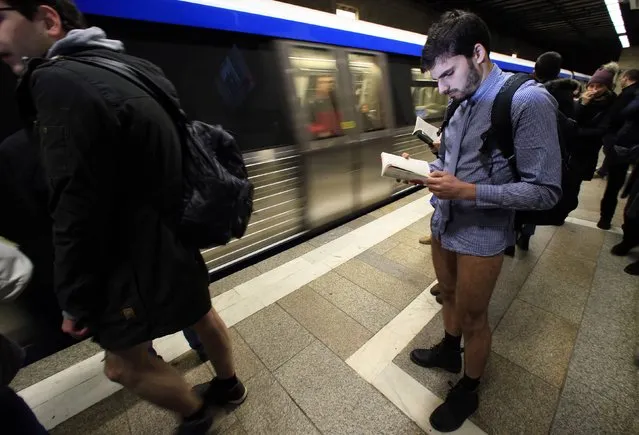 A participant reads a book as he waits for a train during “The No Pants Subway Ride” in Bucharest January 11, 2015. (Photo by Radu Sigheti/Reuters)